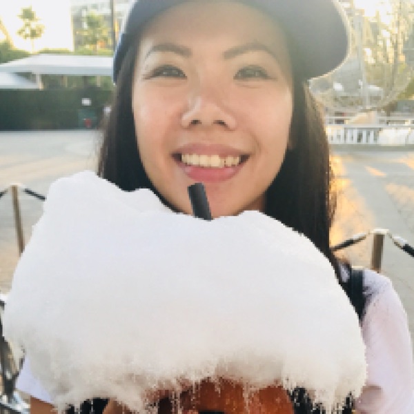Queenie Kung, grinning behind a cotton-candy-topped boba